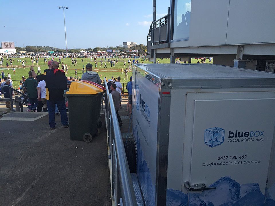 Spectators beside a Bluebox trailer at the grand final