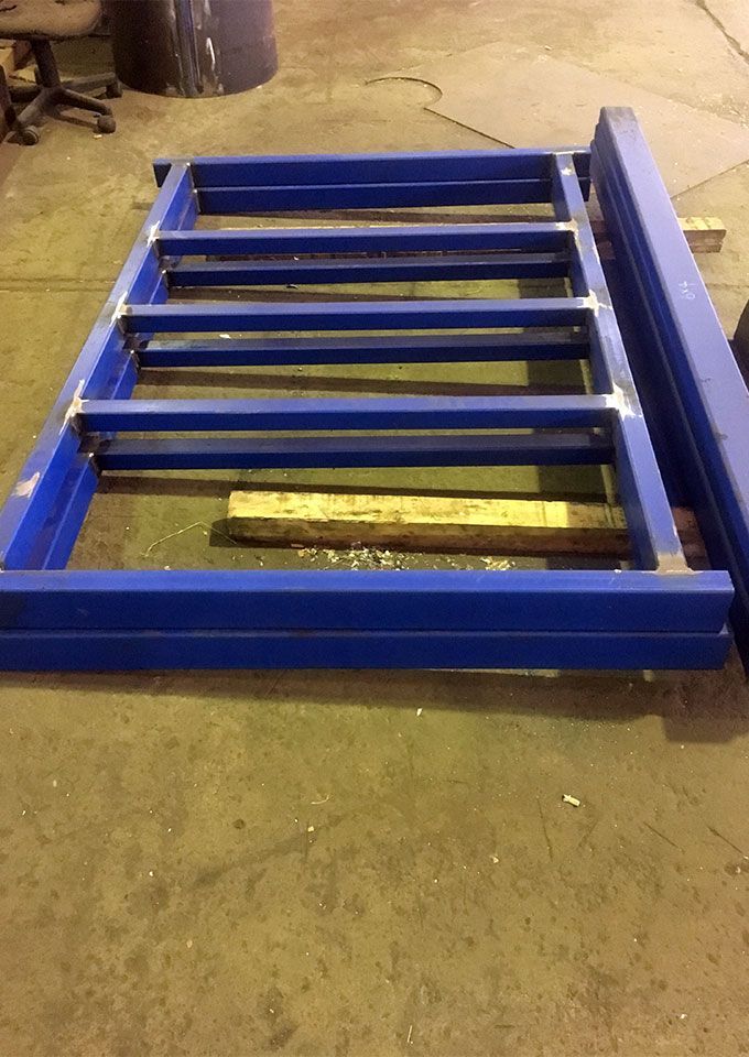 Welded blue trailer chassis under construction